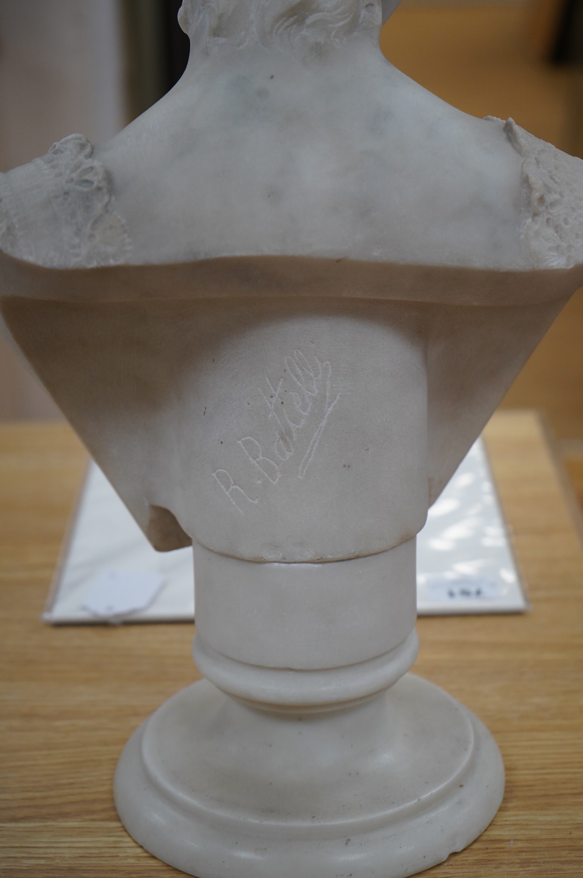 After Rafaello Battelli (Italian), a white marble bust of a lady, 54cm high. Condition - fair to good